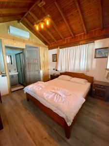 a bedroom with a large bed in a room at Ankh Pension in Kaleucagız