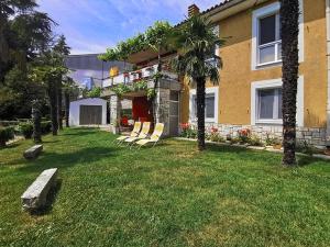 un grupo de sillas sentadas en el patio de una casa en Apartments Nea by Locap Group, en Portorož