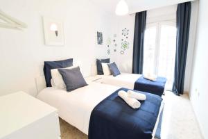 A bed or beds in a room at Letmalaga Popolo & Parking