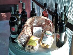 a basket of food and bottles of wine on a table at Tenuta Annibale in Leverano