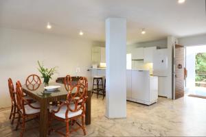 a kitchen and dining room with a table and chairs at Kavouri Flat in Athens