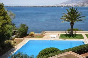 a swimming pool with a view of the water at Kavouri Flat in Athens