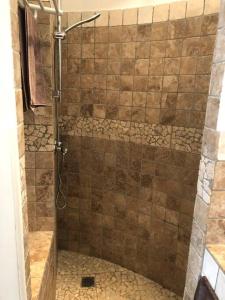 a shower in a bathroom with a tiled floor at Gîte en Pays Cathare in Pomas +28 photos