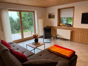 uma sala de estar com um sofá e uma mesa em Schöner Ausblick em Bad Kohlgrub