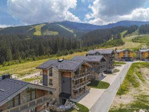 an aerial view of a resort with mountains in the background at ChaletSKI Jasná, SKI-IN & SKI-OUT in Demanovska Dolina
