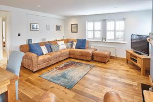 a living room with a couch and a flat screen tv at Host & Stay - Doray House in Newton-by-the-Sea