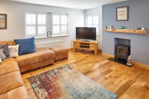 a living room with a couch and a fire place at Host & Stay - Doray House in Newton-by-the-Sea