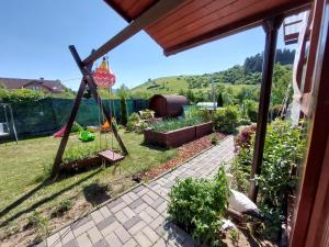 einen Garten mit einer Schaukel im Hof in der Unterkunft Chalupa Miška in Gôtovany