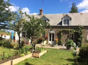 a stone house with a garden in front of it at Le Chalange in Lapenty +10 photos