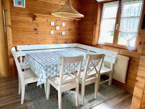 a dining room with a table and chairs in a cabin at Ferienpark Lauterdörfle 7 in Hayingen