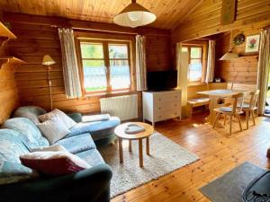 a living room with a couch and a table at Ferienpark Lauterdörfle 4 in Hayingen