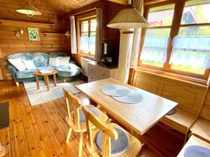 a living room with a table and chairs in a cabin at Ferienpark Lauterdörfle 4 in Hayingen