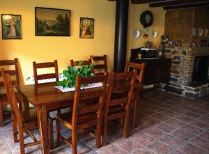 a dining room with a table and chairs and a fireplace at Hotel Rural El Rimero de la Quintina in Yanguas
