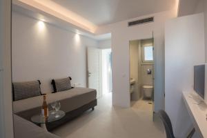 a room with a bed and a table and a television at Alexandros Apartments in Naousa +208 photos