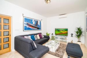a living room with a couch and a tv at Holiday Home King in Dubrovnik