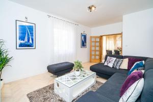 a living room with a couch and a table at Holiday Home King in Dubrovnik