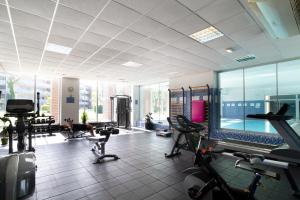 a gym with treadmills and exercise equipment in a building at IBERSOL SPA AQQUARIA SUITES in Salou