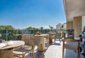 a restaurant with tables and chairs on a balcony at SAVUS Boutique Hotel in Rethymno