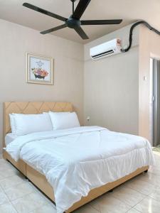 a bedroom with a white bed with a ceiling fan at Homestay Wafiy Lost World Tambun Ipoh in Ipoh