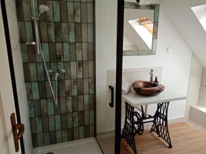 a bathroom with a shower and a sink at MM Apartman in Badacsonyörs