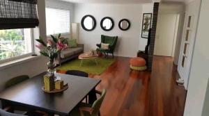 a living room with a table and a couch at Villas Sienna Homestay in Gold Coast