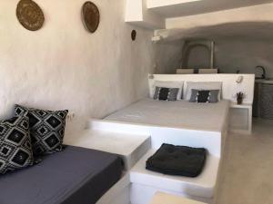 a bedroom with two beds and a couch at Salty Kisses and Sandy Toes in Firopótamos