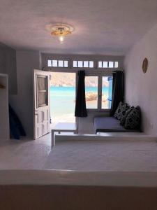 a bedroom with a bed with a view of the ocean at Salty Kisses and Sandy Toes in Firopótamos