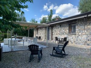 a patio with chairs and a table and an umbrella at I Suoni di Valle Martina in Poderia