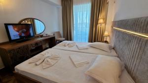 a hotel room with two beds and a television at Hotel Florida Mamaia in Mamaia +28 photos