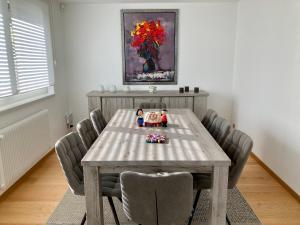 a dining room table with two dolls sitting on it at Gite Les deux belettes in Riquewihr