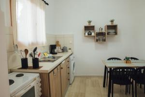 a kitchen with a table and a stove top oven at Pagonia Apartments in Arillas