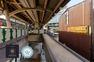 a walkway in a building with a sign on it at StayAt Bedever Bangkok Hotel in Bangkok +33 photos