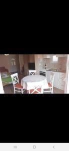a kitchen with a table and chairs in a room at Apartmani Tanja in Tivat