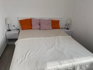 ein Schlafzimmer mit einem weißen Bett mit zwei Lampen in der Unterkunft Mandre - Dalmacija in Mandre