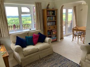 a living room with a couch and a table at The Nest in Modbury