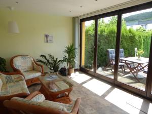 a living room filled with furniture and a large window at Ferienwohnung Hagebuttenweg in Thale +3 photos