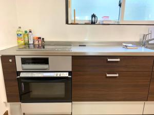 a kitchen with a stove and a counter top at Holiday House Toya in Lake Toya