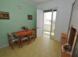 a dining room with a table and a table and chairs at Gallipoli Mancaversa Futura Vacanza Andrea in Marina di Mancaversa
