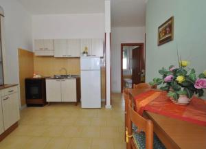 a kitchen and dining room with a table and a refrigerator at Gallipoli Mancaversa Futura Vacanza Andrea in Marina di Mancaversa