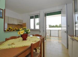 a kitchen and dining room with a table and chairs at Gallipoli Mancaversa Futura Vacanza Andrea in Marina di Mancaversa