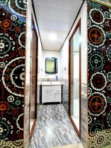 a bathroom with a sink and a mirror at Colibri Traditional Hostel in Samarkand