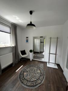 a living room with a rug and a chair and a mirror at Ferienwohnung Sonnengarten in Schönberg