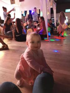 a baby sitting on the floor in a group of people at Beautiful holiday 3 bed Home Camber-sands in Camber +45 photos