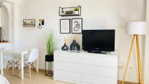 a living room with a tv on a white dresser at Minerva Paradise in Benalmádena