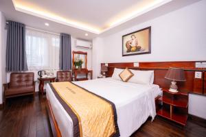 Postel nebo postele na pokoji v ubytování Duc Vuong Saigon Hotel - Bui Vien