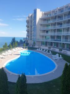 a large swimming pool in front of a building at Studio Silver Terace with Sea View for 4 person in Byala