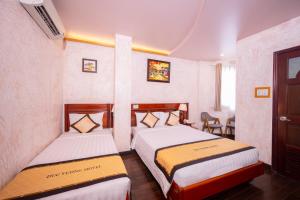 Postel nebo postele na pokoji v ubytování Duc Vuong Saigon Hotel - Bui Vien