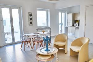 a kitchen and dining room with a table and chairs at EQUORUM Delicious Suite - Ostuni Centro in Ostuni