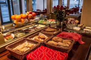 a buffet with baskets of food on a table at Best Western Hotel Apollo in Oulu