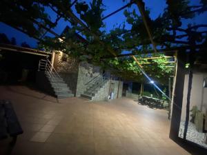 a view of a courtyard at night with stairs at Casa rural O CARBALLO DA PEDRA in La Cañiza